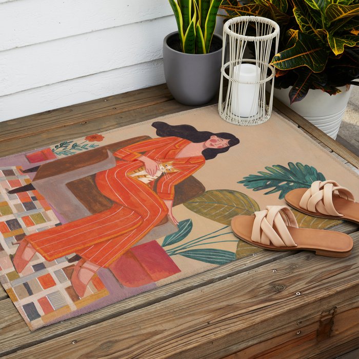 Woman with cat in living room in warm earth tones Outdoor Rug Gallery Image 2