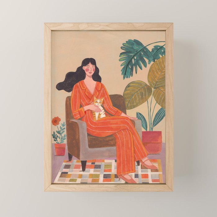Woman with cat in living room in warm earth tones Mini Art Print Gallery Image 1