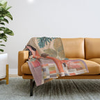 Woman with cat in living room in warm earth tones Throw Blanket Gallery Image 1