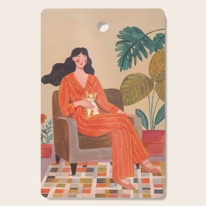 Woman with cat in living room in warm earth tones Cutting Board Gallery Image 1