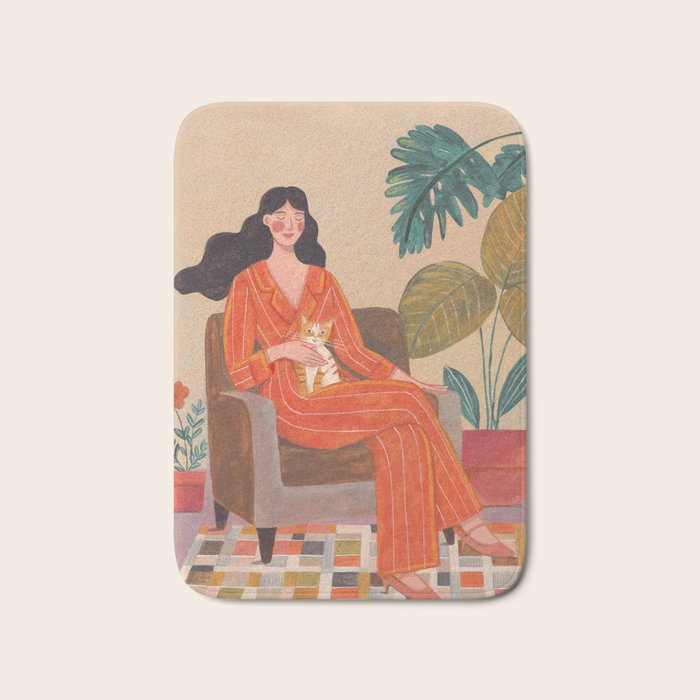 Woman with cat in living room in warm earth tones Bath Mat Gallery Image 1