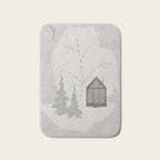 a wooden house in a snowy forest Bath Mat Gallery Image 1