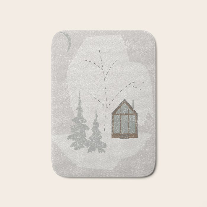a wooden house in a snowy forest Bath Mat Gallery Image 1