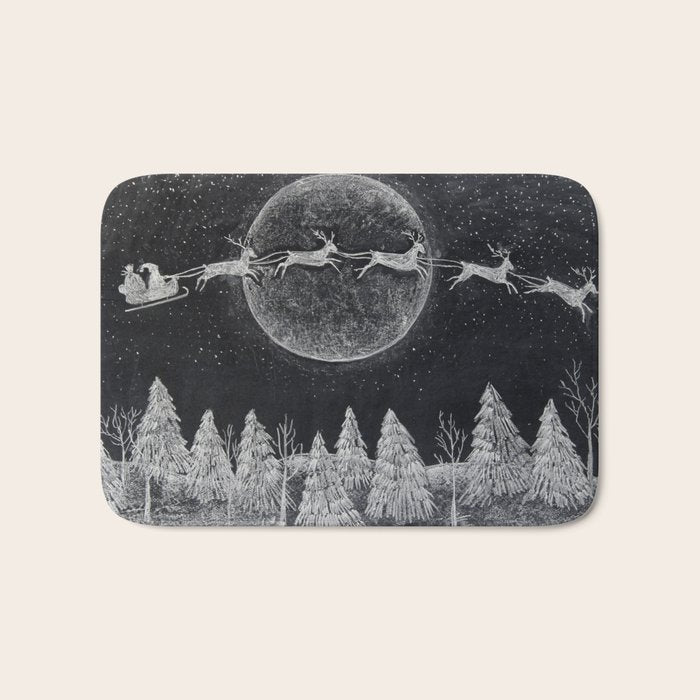 Santa flying over a winter wonderland of snow covered trees in his reindeer drawn sleigh by the light of a full moon Bath Mat
