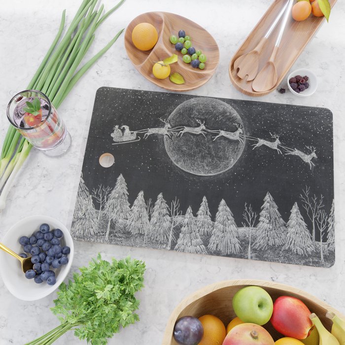 Santa flying over a winter wonderland of snow covered trees in his reindeer drawn sleigh by the light of a full moon Cutting Board Gallery Image 2