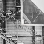 Escape from New York fire escape symmetrical steel staircase architecture black and white photograph Wall Tapestry Gallery Image 3
