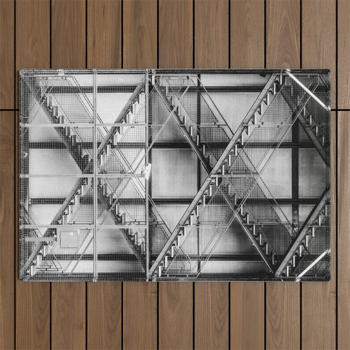 Escape from New York fire escape symmetrical steel staircase architecture black and white photograph Outdoor Rug Gallery Image 1