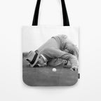 Eye to the ground on the 18th hole; golfing man eyes ball to measure distance to hole vintage black and white portrait photograph - photography - photographs poster Tote Bag Gallery Image 1