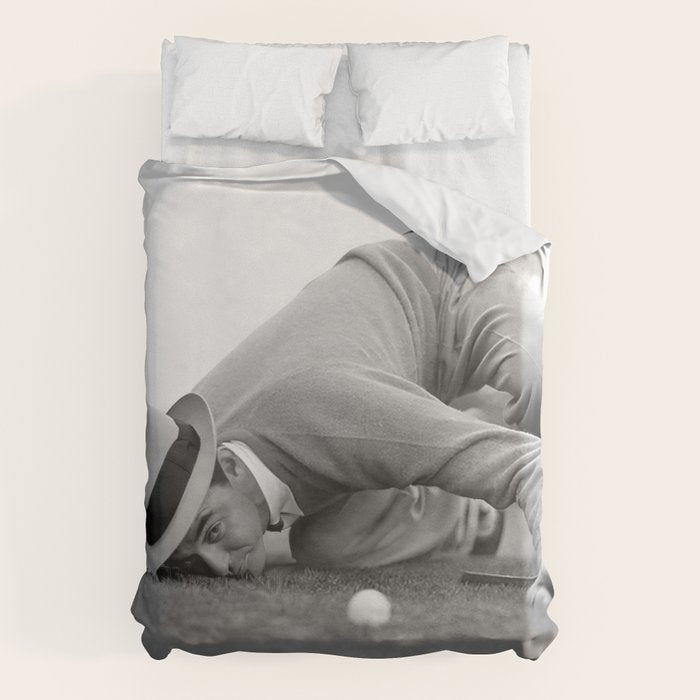Eye to the ground on the 18th hole; golfing man eyes ball to measure distance to hole vintage black and white portrait photograph - photography - photographs poster Duvet Cover Gallery Image 1