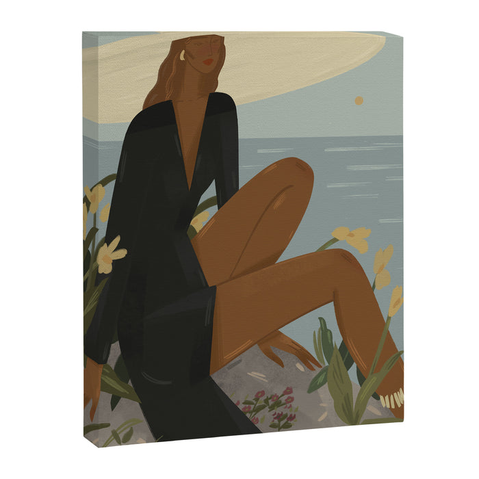 a woman in a black dress on the seashore Canvas Print Gallery Image 1