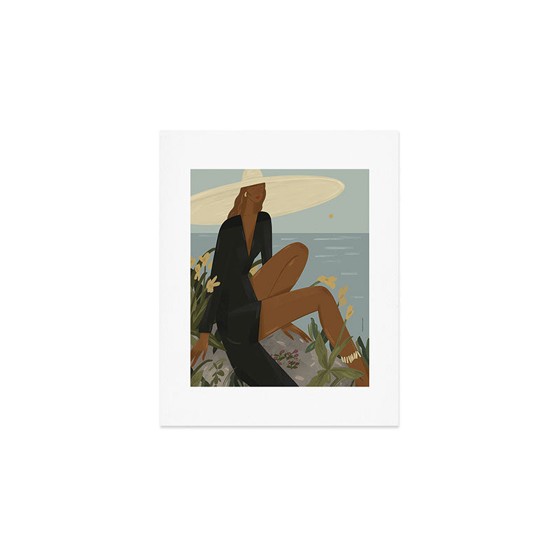 a woman in a black dress on the seashore Art Print Gallery Image 1