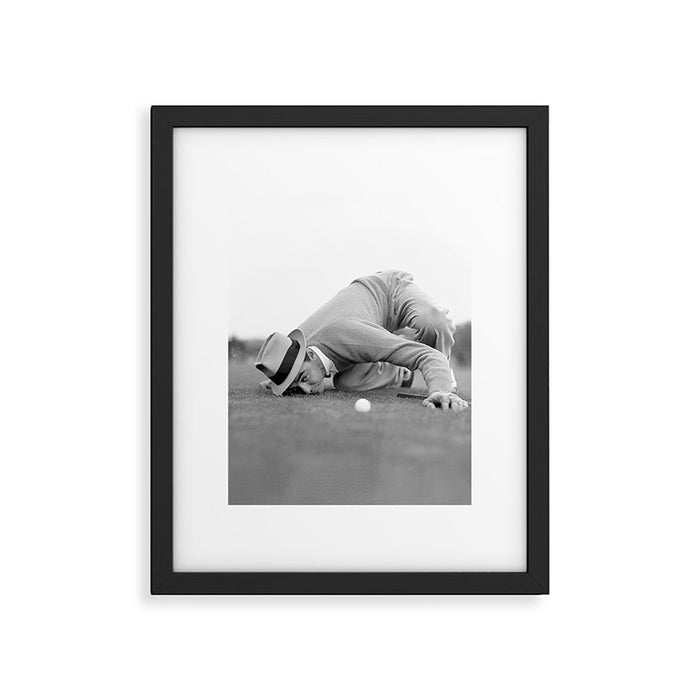 Eye to the ground on the 18th hole; golfing man eyes ball to measure distance to hole vintage black and white portrait photograph - photography - photographs poster Framed Art Print Gallery Image 1