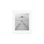 Steady As She Goes 6; aircraft coming in for an island landing female in bikini black and white photography - photographs - photograph Art Print Gallery Image 1