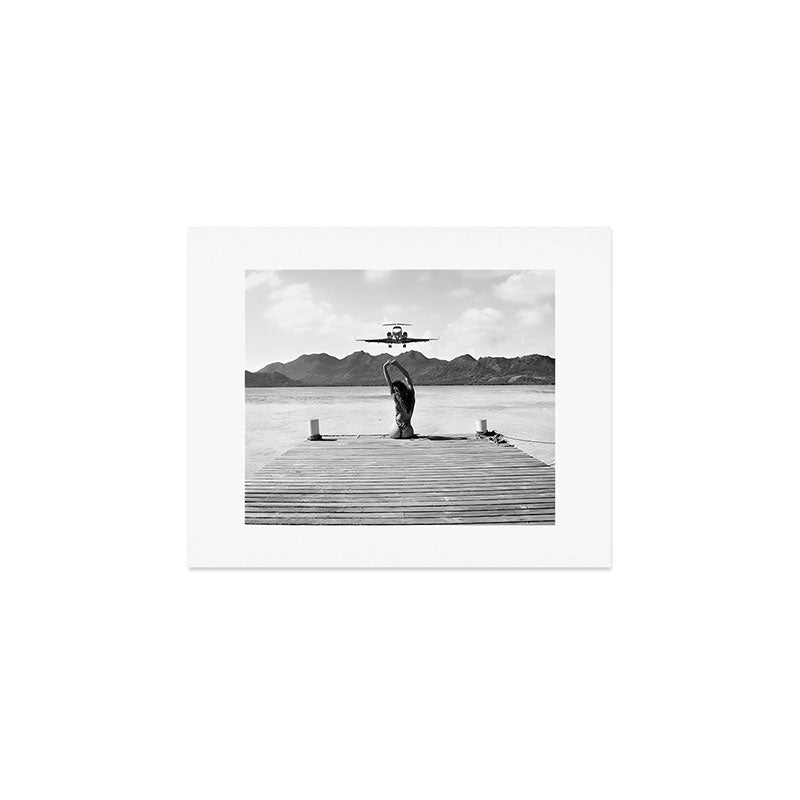 Steady as she goes girl in bikini on a dock with plane landing black and white photograph Art Print Gallery Image 1