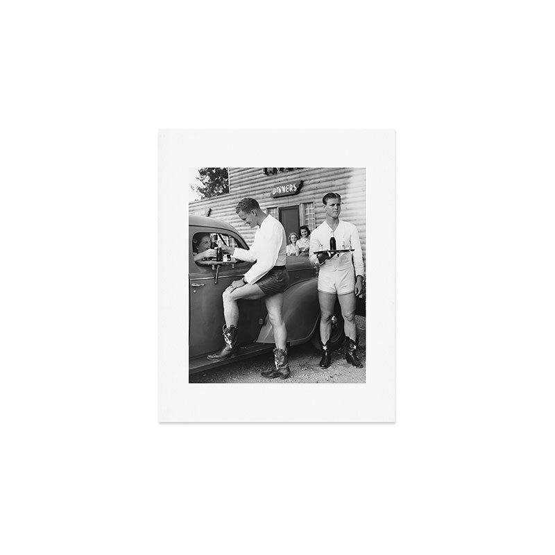 Texas love, male drive-in car hops in shorts and cowboy boots at drive in tavern near Love Field Airport in Dallas vintage black and white photograph - photography - photographs Art Print Gallery Image 1