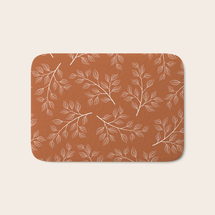 Delicate White Leaves and Branch on a Rust Orange Background Bath Mat Gallery Image 1