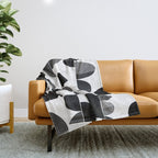 Mid Century Abstract cut-out Pebbles 3. Black and white Throw Blanket Gallery Image 1