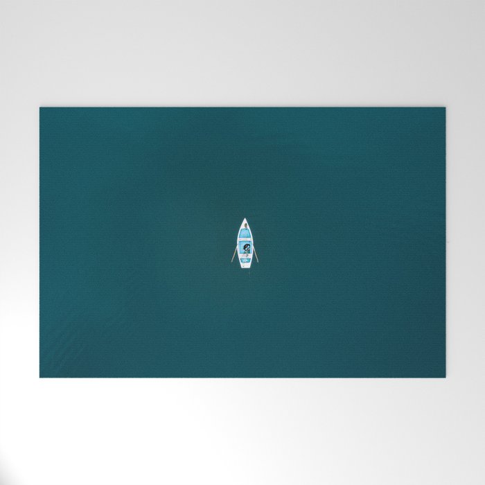 Minimalist Boat in blue Lake  Welcome Mat Gallery Image 1