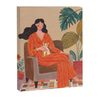 Woman with cat in living room in warm earth tones Canvas Print Gallery Image 3