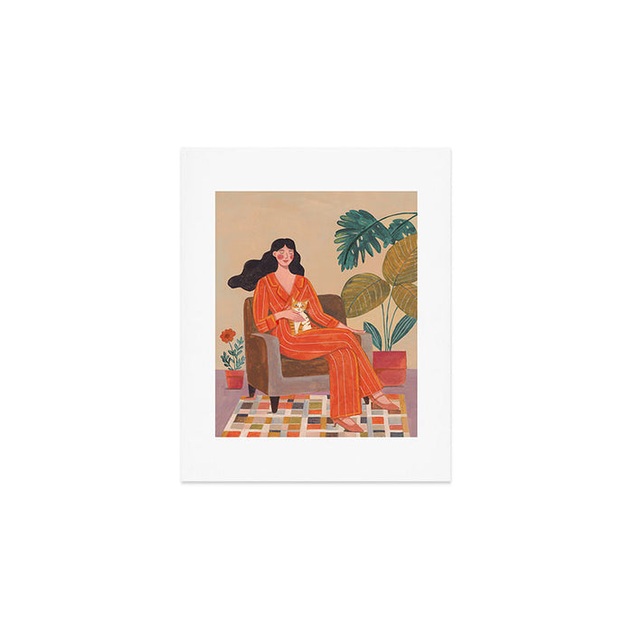 Woman with cat in living room in warm earth tones Art Print Gallery Image 1