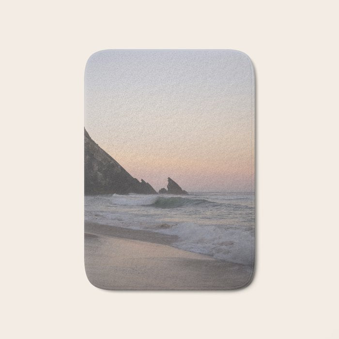 Pastel orange sunrise at Praia da Adraga in Portugal - summer coastal travel photography Bath Mat Gallery Image 1