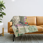 Woman reading on balcony Throw Blanket Gallery Image 1