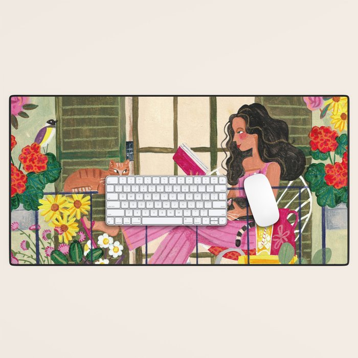 Woman reading on balcony Desk Mat Gallery Image 1
