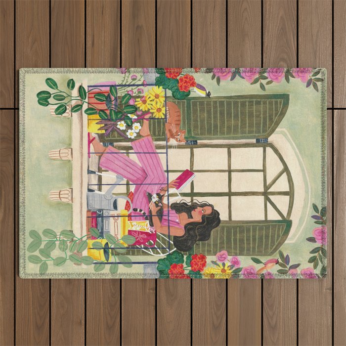 Woman reading on balcony Outdoor Rug Gallery Image 1