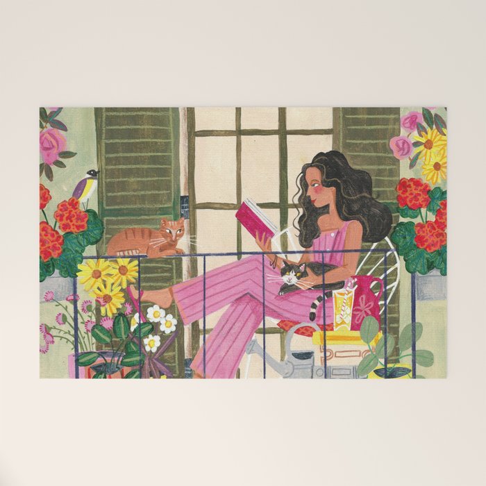 Woman reading on balcony Welcome Mat Gallery Image 1