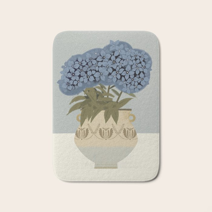 bouquet of lush blue hydrangeas in a vase on a blue background Bath Mat Gallery Image 1