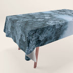 Man lying in the snow on a frozen lake in a winter forest - Landscape Photography Tablecloth Gallery Image 1