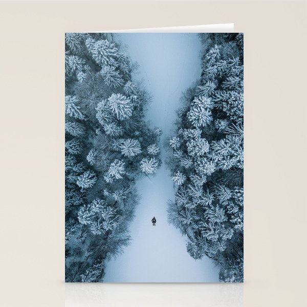 Man lying in the snow on a frozen lake in a winter forest - Landscape Photography Stationery Card Gallery Image 2