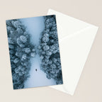 Man lying in the snow on a frozen lake in a winter forest - Landscape Photography Stationery Card Gallery Image 2