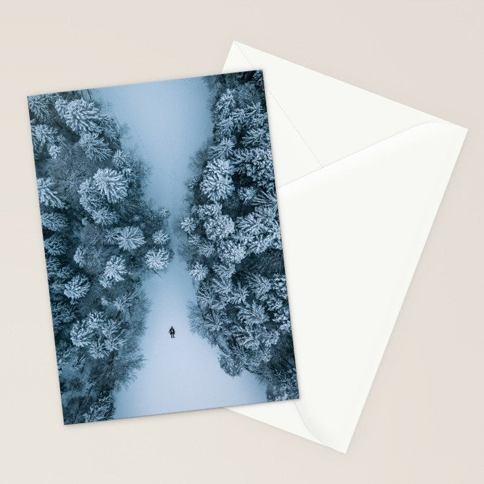 Man lying in the snow on a frozen lake in a winter forest - Landscape Photography Stationery Card Gallery Image 2