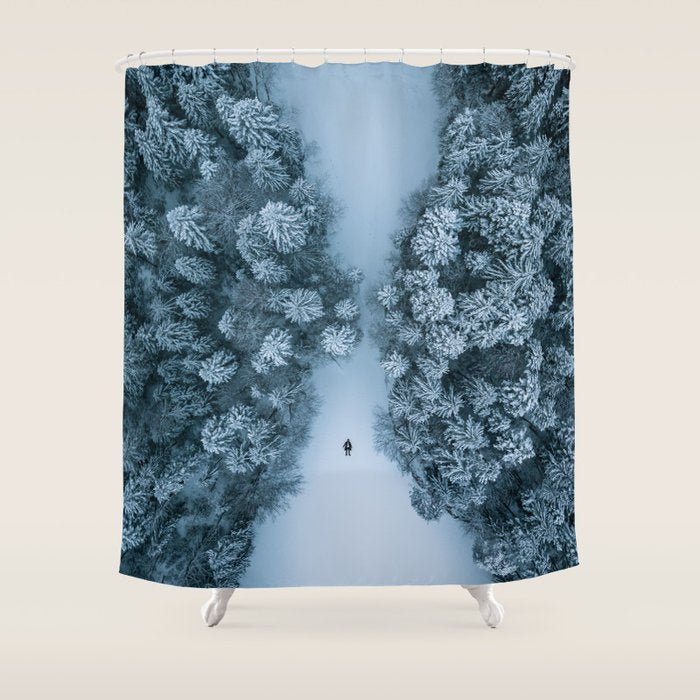 Man lying in the snow on a frozen lake in a winter forest - Landscape Photography Shower Curtain Gallery Image 1
