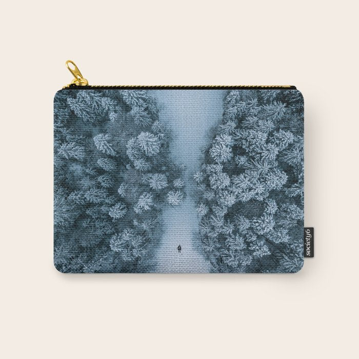 Man lying in the snow on a frozen lake in a winter forest - Landscape Photography Carry All Pouch Gallery Image 1