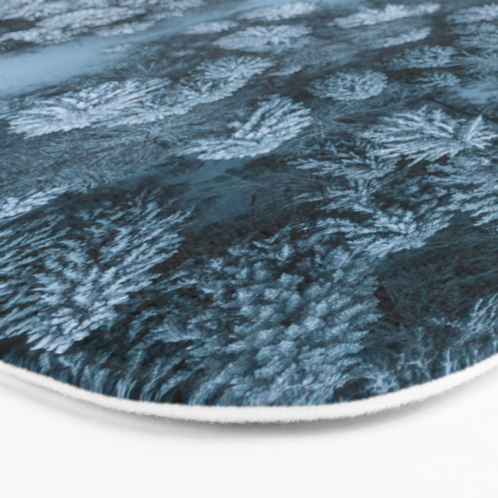 Man lying in the snow on a frozen lake in a winter forest - Landscape Photography Bath Mat Gallery Image 3