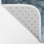 Man lying in the snow on a frozen lake in a winter forest - Landscape Photography Bath Mat Gallery Image 2