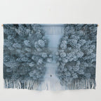 Man lying in the snow on a frozen lake in a winter forest - Landscape Photography Wall Hanging Gallery Image 1