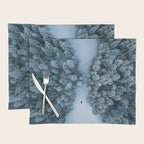 Man lying in the snow on a frozen lake in a winter forest - Landscape Photography Placemat Gallery Image 1