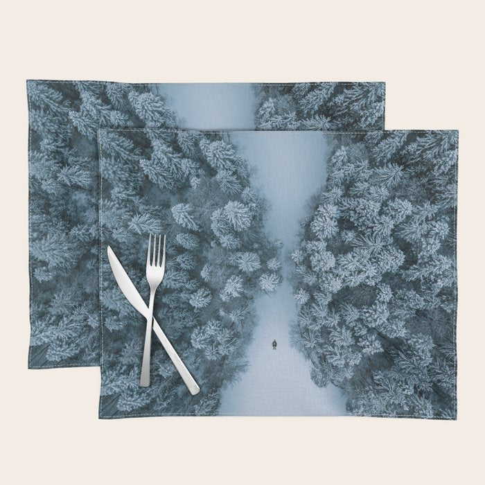 Man lying in the snow on a frozen lake in a winter forest - Landscape Photography Placemat Gallery Image 1