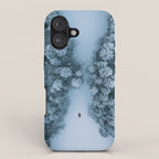 Man lying in the snow on a frozen lake in a winter forest - Landscape Photography iPhone Case Gallery Image 1