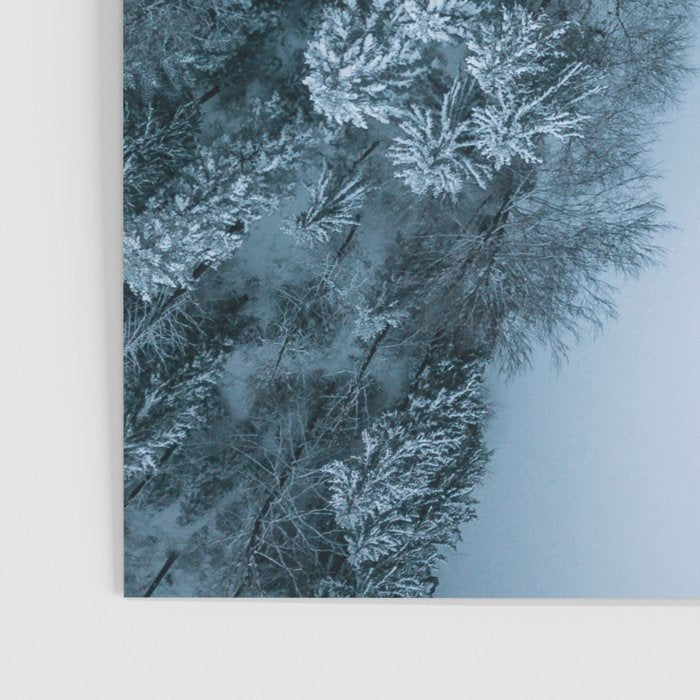 Man lying in the snow on a frozen lake in a winter forest - Landscape Photography Poster Gallery Image 3