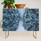 Man lying in the snow on a frozen lake in a winter forest - Landscape Photography Credenza Gallery Image 1