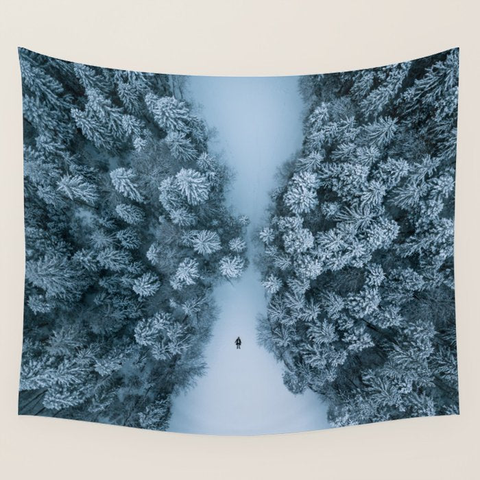Man lying in the snow on a frozen lake in a winter forest - Landscape Photography Wall Tapestry Gallery Image 4