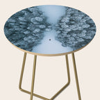 Man lying in the snow on a frozen lake in a winter forest - Landscape Photography Side Table Gallery Image 2