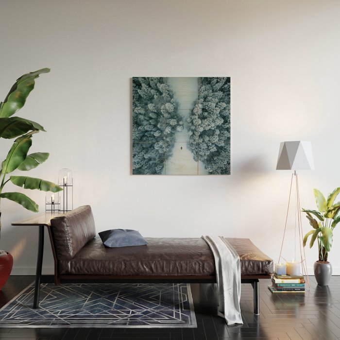 Man lying in the snow on a frozen lake in a winter forest - Landscape Photography Wood Wall Art Gallery Image 2