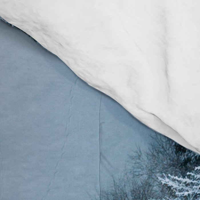 Man lying in the snow on a frozen lake in a winter forest - Landscape Photography Comforter Gallery Image 4