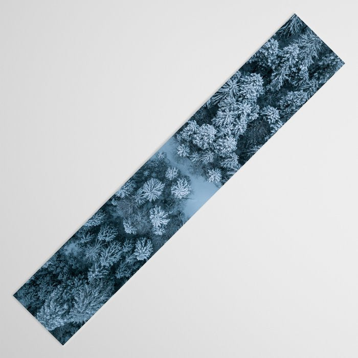 Man lying in the snow on a frozen lake in a winter forest - Landscape Photography Table Runner Gallery Image 3