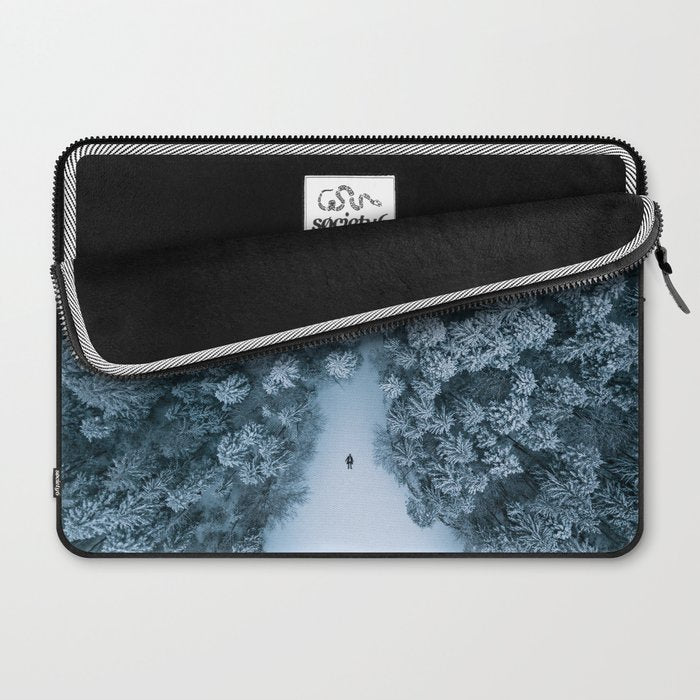 Man lying in the snow on a frozen lake in a winter forest - Landscape Photography Laptop Sleeve Gallery Image 2
